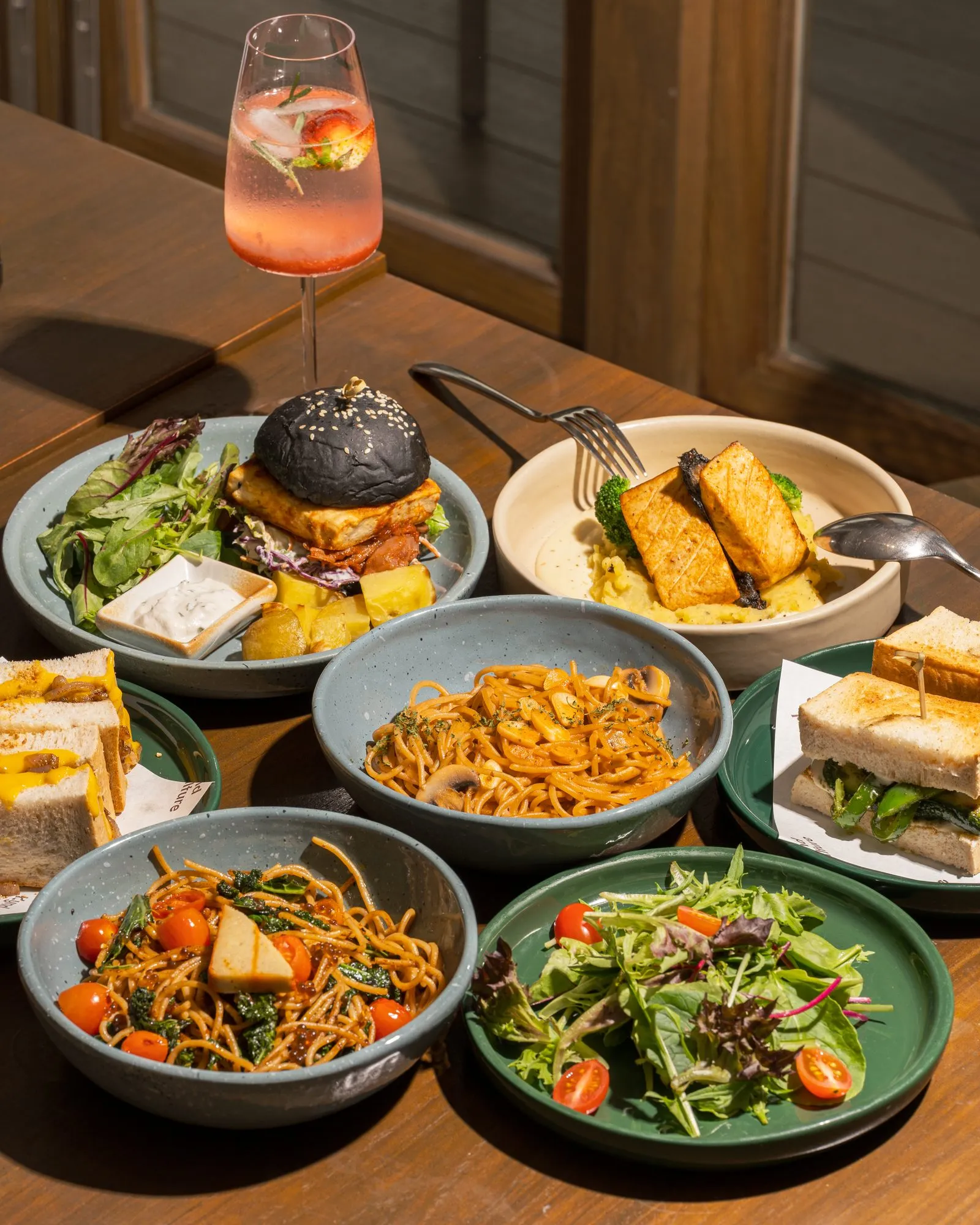 Sharing table full of plant-based dishes at Kynd Kulture, Bangkok